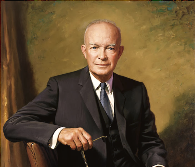 President Dwight D. Eisenhower seated beside a table in a formal portrait.