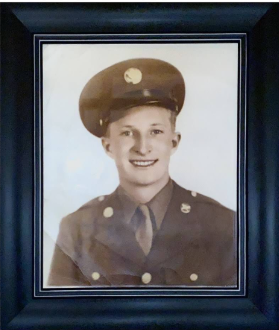 Framed color portrait of a smiling serviceman in a military uniform.