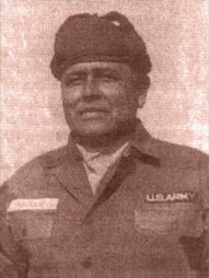 Serviceman wearing a military field uniform and cap.