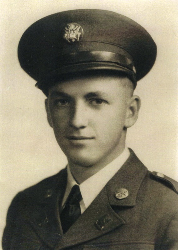 Young serviceman wearing a military uniform and peaked cap.