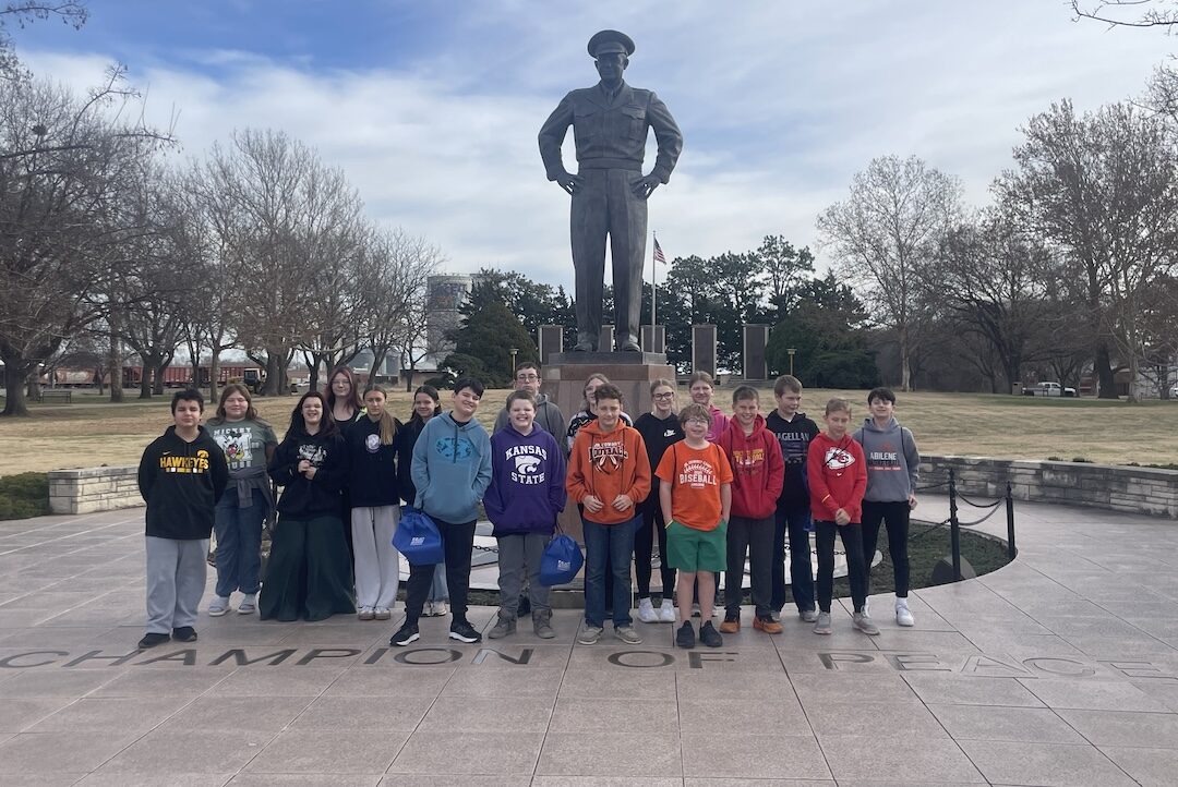 students by the Eisenhower statue
